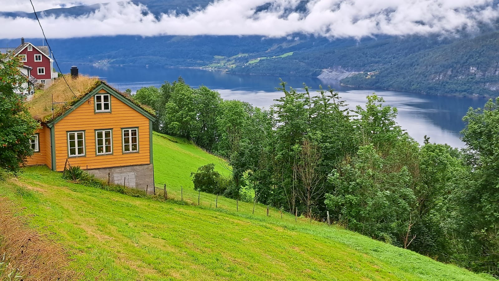 A typical colorful turf-roofed house along the trail to Tvinnefossen, above the fjord