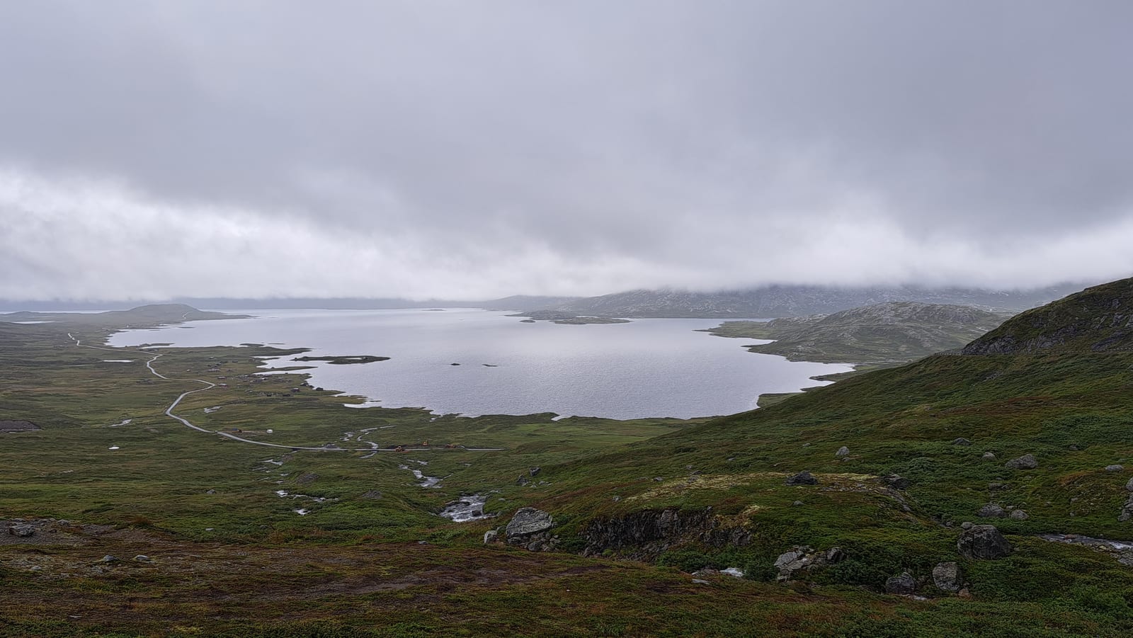 Lake Gjende wrapped in fog, along the Valdresflye plateau