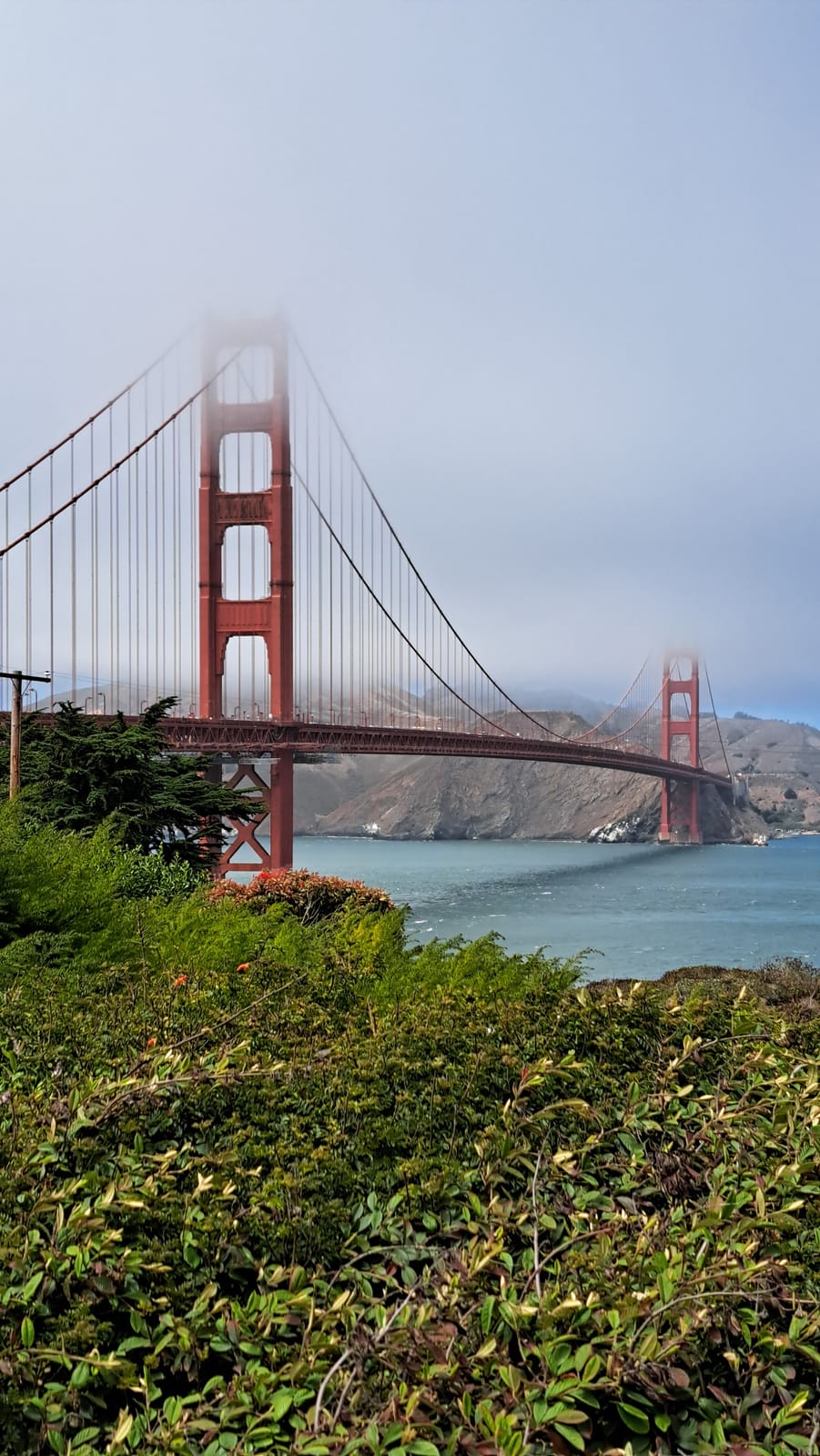 The Golden Gate Bridge, its north tower wrapped in fog
