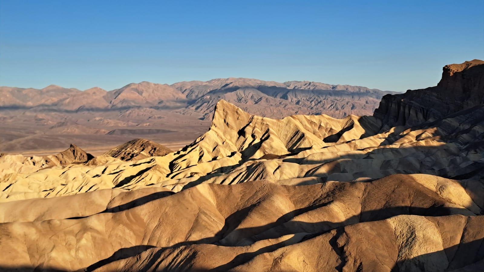 Sunrise light over the eroded badlands at Zabriskie Point