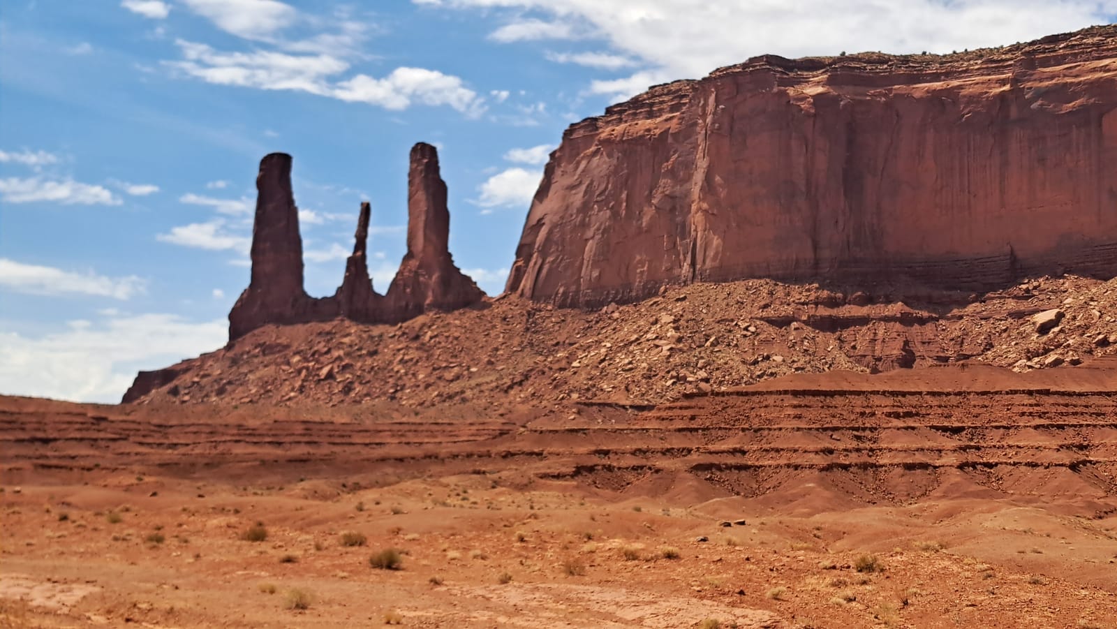 Rock spires beside a mesa, seen on the Navajo-guided tour of Monument Valley